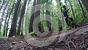 Woman riding unicycle in the forest 4k