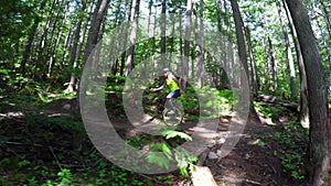 Woman riding unicycle in forest path 4k