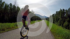 Woman riding unicycle on the road 4k