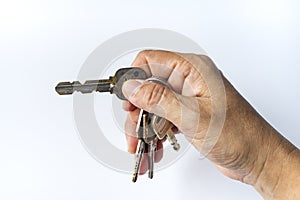 Woman right hand use keys for lock or unlock in white background, Close up & Macro shot, Selective focus, Security concept