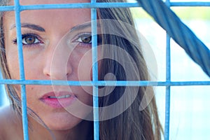 Woman rights defence locked fence in cage portrait