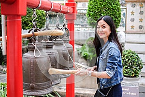 Woman ringing a bell in a Buddhist temple