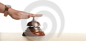 Woman ringing hotel service bell at table