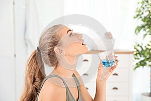 Woman rinsing mouth with mouthwash