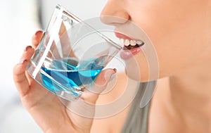 Woman rinsing mouth with mouthwash