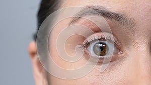 Woman rising her eyebrow, shocked or surprised by information, macro slow-mo