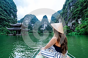 A woman on a river boat in Ninh Binh. Mountains of northern Vietnam.