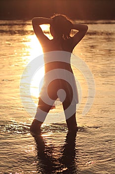 Woman in River in Sunset