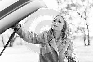 Woman on a road with a car