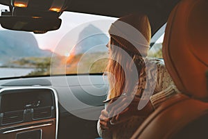 Woman on road trip traveling by rental car relaxing with coffee cup