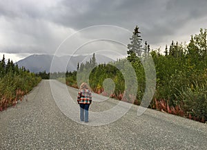 Woman on Road in Wilderness off the Alaska Canada Highway