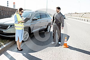 Woman and road worker during the car accident