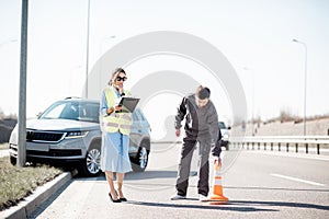 Woman and road worker during the car accident