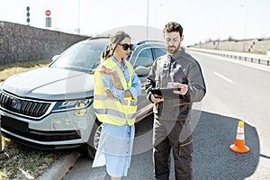 Woman with road worker during the road accident