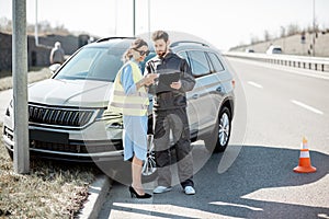 Woman with road worker during the road accident