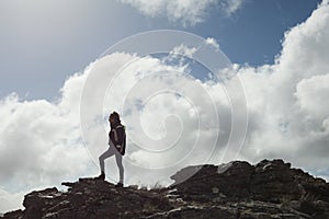 Woman on rock admiring the view after a hike