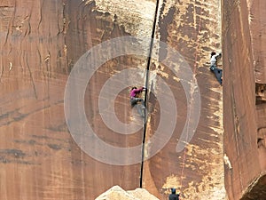 A woman rock climbing at canyonlands, utah