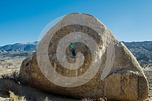 Woman Rock Climbing a Large Boulder