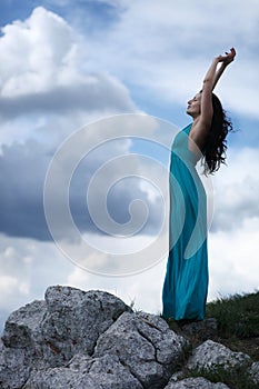 Woman on rocky mountain clif