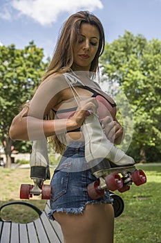 Woman with roller skates on the shoulder