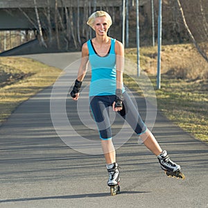 Woman roller skating in park smiling summer