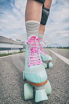 Woman rollerskater wearing knee protector pads