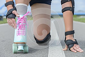 Woman rollerskater wearing knee protector pads