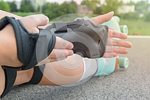 Woman rollerskater wearing wrist guards protector pads