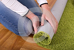 Woman rolling carpet