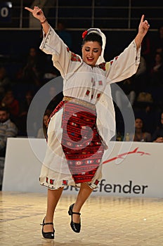 Woman in Romanian national outfit perform during dancesport competition