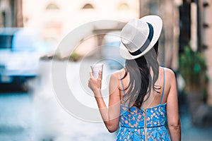 Woman in Rome with coffee to go on vacation travel.