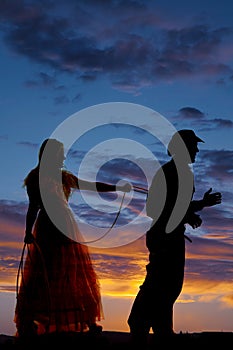 Woman with a rope around a cowboy silhouette