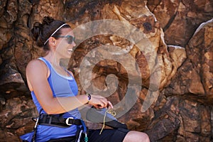 Woman, rope and rock climbing with shoes, adventure and laugh outdoor in the mountain. Training, exercise and workout