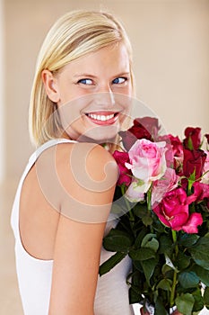 Woman, rose bouquet and smile with face, beauty and arrangement with studio background, happy and gift. Look, female
