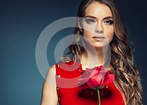 Woman with rose flower. Beauty female portrait with beautiful rose flower and salon hairstyle over gay blue background blonde hair
