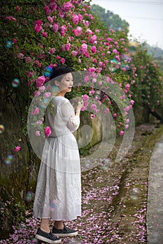 Woman in rose garden