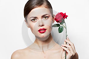Woman with rose Red lips bared shoulders charm bright makeup