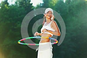 Woman rotates hula hoop photo