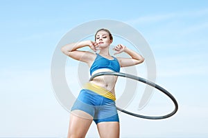 Woman rotates hula hoop