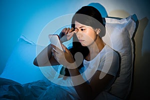 Woman rubbing eyes with using smartphone