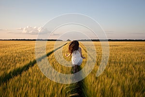 Woman run in yellow wheat field