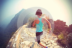 Woman runner athlete running on trail at chinese great wall