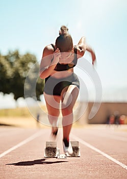 Woman runner, competition race and athlete performance, power and cardio fitness on stadium running track. Motion blur