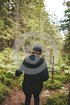 Woman runner in the forest. Endurance training with nature