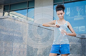 Woman runner is having break, drinking water