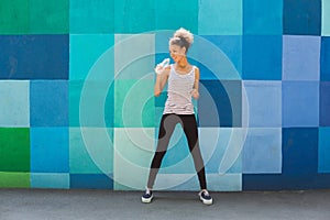 Woman runner is having break, drinking water