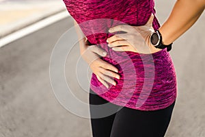 Woman runner having stomach cramps after running Jogging