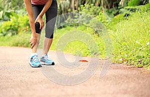 Woman runner holder her sports injured knee