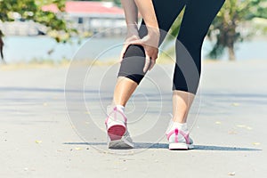 Woman runner leg and muscle pain during running outdoors