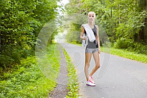 Woman runner rests after workout outdoor